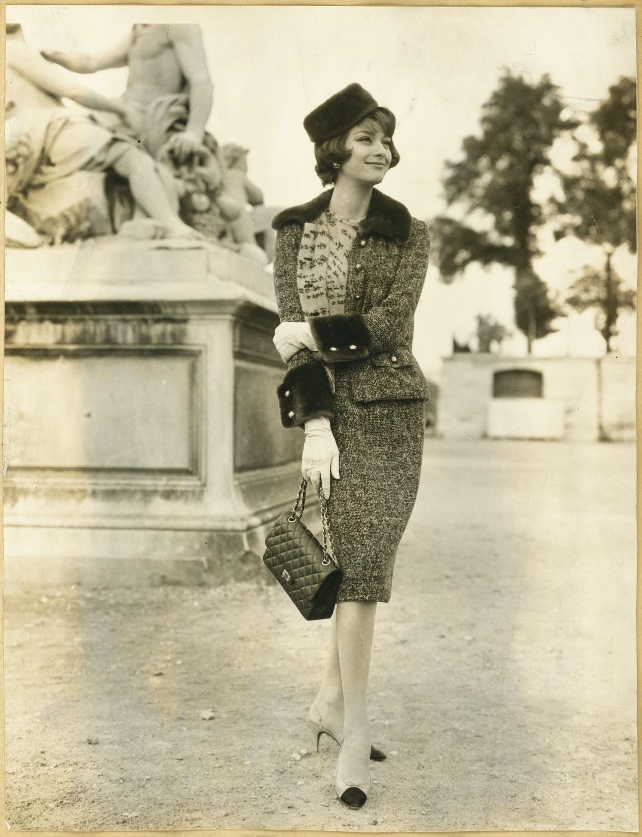 Marie-Hélène Arnaud in a tweed suit from Chanel’s Fall-Winter 1959 collection and Chanel shoes, carrying the 2.55 Chanel handbag. © CHANEL / All Rights Reserved